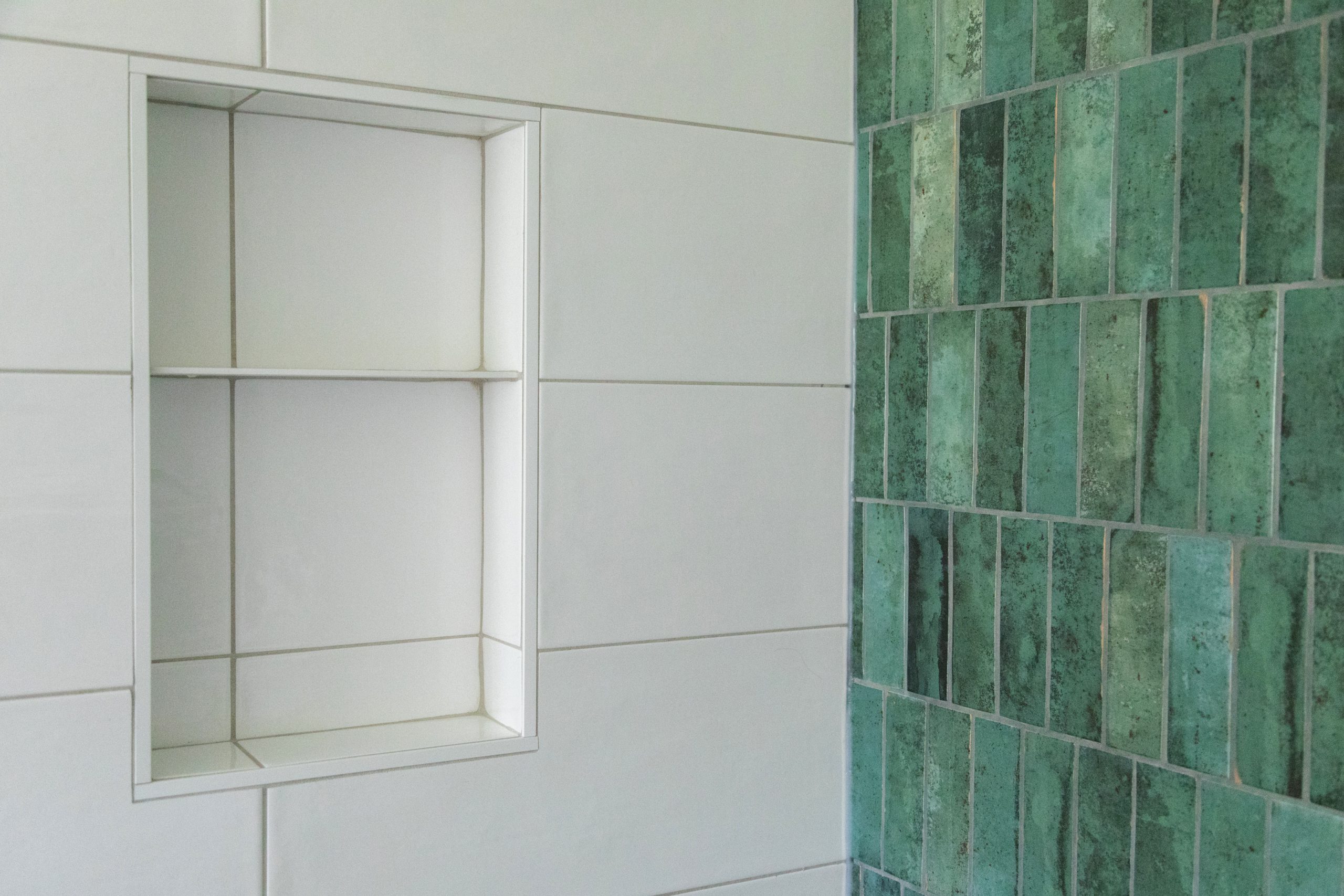 a close up of the bathroom tile and niche